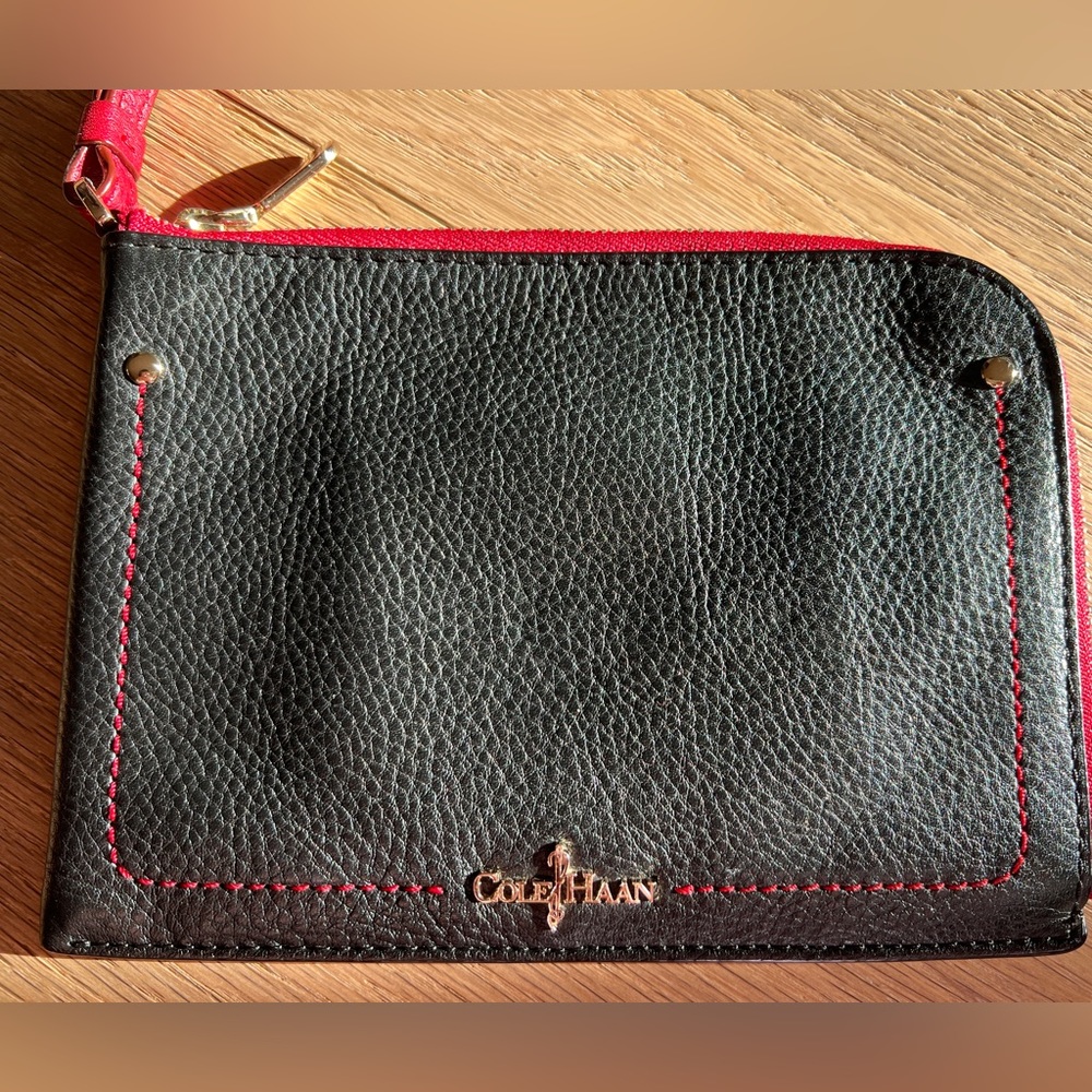 Cole Haan Pebbled Leather Wristlet - black with red trim and wrist strap.